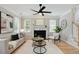 Bright living room with fireplace, white mantel, and decorative ceiling fan at 683 Terry Se St, Atlanta, GA 30315