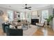 Bright living room featuring hardwood floors, multiple windows, stylish furnishings, and a cozy fireplace at 683 Terry Se St, Atlanta, GA 30315
