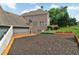 Large backyard with manicured beds and wood retaining walls at 525 Wallis Farm Ln, Marietta, GA 30064