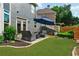 Backyard patio with an outdoor seating area, grass and landscaping at 525 Wallis Farm Ln, Marietta, GA 30064