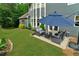 Spacious backyard with seating, lawn, landscaping, and an umbrella for shade at 525 Wallis Farm Ln, Marietta, GA 30064