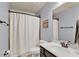 Bathroom with shower/tub, framed mirror, dark vanity and a toilet with blueish-gray walls at 525 Wallis Farm Ln, Marietta, GA 30064