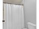 Bright bathroom featuring a white shower curtain and toilet at 525 Wallis Farm Ln, Marietta, GA 30064