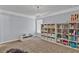 Bedroom or playroom with carpet, built in shelving, and room for toy and game storage at 525 Wallis Farm Ln, Marietta, GA 30064