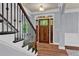 Bright and welcoming foyer features hardwood floors, stylish staircase and glass-paneled door for an inviting entrance to the home at 525 Wallis Farm Ln, Marietta, GA 30064