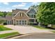 Charming two-story home features a brick and siding facade, three car garage and a beautifully landscaped front yard at 525 Wallis Farm Ln, Marietta, GA 30064