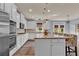 Bright kitchen featuring white cabinets, granite countertops, and a large center island with seating at 525 Wallis Farm Ln, Marietta, GA 30064