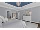 Spacious main bedroom showcasing a tray ceiling, a chandelier, and stylish furniture at 525 Wallis Farm Ln, Marietta, GA 30064