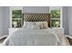 Elegant main bedroom features a tufted headboard, neutral color palette, and abundant natural light at 525 Wallis Farm Ln, Marietta, GA 30064