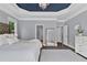 Bright main bedroom showcasing tray ceilings, chandelier, and a spacious layout at 525 Wallis Farm Ln, Marietta, GA 30064