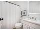 Clean bathroom with a framed mirror, shower and white fixtures at 6788 Oakhurst Court Ct, Douglasville, GA 30134