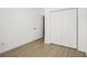 This bedroom features wood-look floors and a closet for organized storage at 6788 Oakhurst Court Ct, Douglasville, GA 30134
