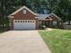 Charming brick home with a well-manicured lawn, attached garage, and inviting front entrance at 6788 Oakhurst Court Ct, Douglasville, GA 30134