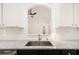 Granite kitchen counter with stainless steel sink and white subway tile backsplash at 6788 Oakhurst Court Ct, Douglasville, GA 30134