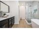 Bright main bathroom featuring a glass-enclosed shower, soaking tub, and modern vanity at 6788 Oakhurst Court Ct, Douglasville, GA 30134