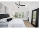 Spacious main bedroom with tray ceiling, large windows, and wood-look flooring at 6788 Oakhurst Court Ct, Douglasville, GA 30134