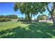 Expansive backyard featuring a fire pit, mature trees, and a wooden fence at 11 Trotters Ne Walk, Cartersville, GA 30121