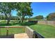 Spacious backyard with lush grass, mature trees, and a wooden fence at 11 Trotters Ne Walk, Cartersville, GA 30121