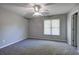 Neutral bedroom featuring a ceiling fan, window, and neutral carpeting at 11 Trotters Ne Walk, Cartersville, GA 30121