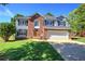 Charming two-story home with a well-manicured lawn, two-car garage and inviting brick accents at 11 Trotters Ne Walk, Cartersville, GA 30121