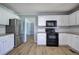 Updated kitchen boasts stainless steel appliances, granite countertops, and white cabinetry at 11 Trotters Ne Walk, Cartersville, GA 30121