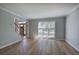 Living room with wood-look floors and large windows at 11 Trotters Ne Walk, Cartersville, GA 30121