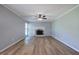 Spacious living room with wood flooring, a ceiling fan, and a cozy fireplace at 11 Trotters Ne Walk, Cartersville, GA 30121