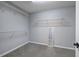 Spacious walk-in closet featuring wall-mounted shelves and neutral carpeting at 11 Trotters Ne Walk, Cartersville, GA 30121