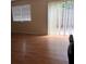 Bright living room featuring wood floors, sliding glass doors, and modern blinds at 1151 Rankin St # 21A, Stone Mountain, GA 30083