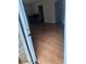 View from doorway of living area with wood floors, adjacent to a dining space and kitchen at 1151 Rankin St # 21A, Stone Mountain, GA 30083