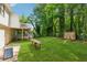 This backyard features ample greenery, and a two-story house with an exterior deck at 185 Hickory View Dr, Lawrenceville, GA 30046