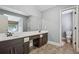 Bright bathroom featuring a double sink vanity with a large mirror and tiled floors at 185 Hickory View Dr, Lawrenceville, GA 30046