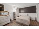 This bedroom features wood floors, a neutral color palette, and modern décor at 185 Hickory View Dr, Lawrenceville, GA 30046