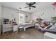 Bright bedroom with a ceiling fan, desk, bed, and sitting area with window views at 185 Hickory View Dr, Lawrenceville, GA 30046