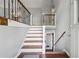 View of the home's entryway with wood and white stairs and natural light at 185 Hickory View Dr, Lawrenceville, GA 30046
