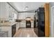 View of the bright kitchen with white cabinets and black appliances at 185 Hickory View Dr, Lawrenceville, GA 30046