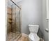 Shower with glass doors and tiled walls, complemented by a standard toilet at 185 Hickory View Dr, Lawrenceville, GA 30046
