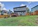 Spacious backyard with a wooden fence, lush lawn, and the exterior of the two-story home at 200 Mona Ct, Lawrenceville, GA 30044