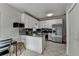 Bright kitchen features stainless steel appliances, granite countertops and tiled floor at 200 Mona Ct, Lawrenceville, GA 30044
