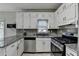 Modern kitchen featuring granite countertops, stainless steel appliances, and plenty of cabinet space at 200 Mona Ct, Lawrenceville, GA 30044