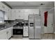 Functional kitchen featuring stainless appliances, stylish cabinetry, and granite countertops at 200 Mona Ct, Lawrenceville, GA 30044