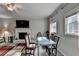 Bright living room with a fireplace, large windows, and a glass table with chairs at 200 Mona Ct, Lawrenceville, GA 30044
