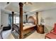 Beautiful primary bedroom with tray ceiling, four poster bed, and accent lamps at 200 Mona Ct, Lawrenceville, GA 30044