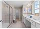 Bright bathroom featuring a glass enclosed shower, double sink vanity, and neutral color palette at 2545 Dixon Pl, Lawrenceville, GA 30045