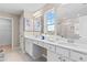 Bright bathroom featuring a glass enclosed shower, double sink vanity, and large window at 2545 Dixon Pl, Lawrenceville, GA 30045