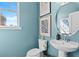 Cozy half bathroom featuring a stylish sink, toilet, and elegant decorations at 2545 Dixon Pl, Lawrenceville, GA 30045