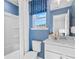Bright blue bathroom with a tub and shower combination at 2545 Dixon Pl, Lawrenceville, GA 30045