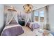 Charming bedroom featuring twin beds, Eiffel Tower mural, whimsical decor, and plenty of natural light at 2545 Dixon Pl, Lawrenceville, GA 30045