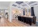 Elegant dining room with coffered ceilings, wood floors, and modern chandelier at 2545 Dixon Pl, Lawrenceville, GA 30045