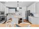 Bright kitchen with stainless steel appliances, white cabinets, and a large island with stone countertop at 2545 Dixon Pl, Lawrenceville, GA 30045